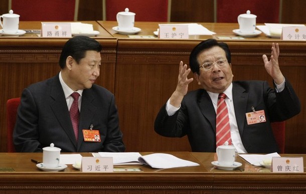 China's former Vice President Zeng gestures as he talks with his successor Xi during a plenary session of China's parliament in Beijing