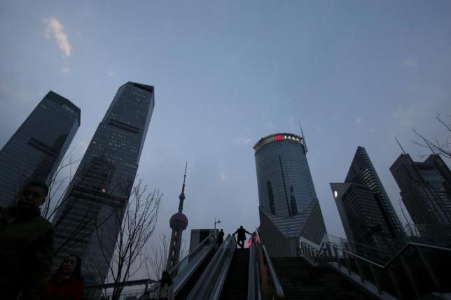A man rides an escalator in the financial district of Pudong in Shanghai