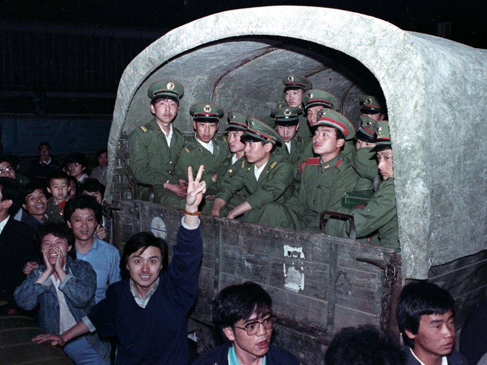 1989年5月20日，北京市民围住解放军官兵，阻止他们前往天安门广场（图源：Reuters/VCG）